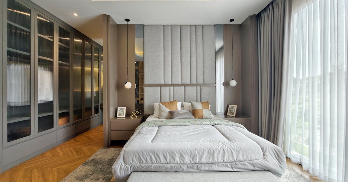 Luxurious modern bedroom design featuring large windows and sophisticated decor.
