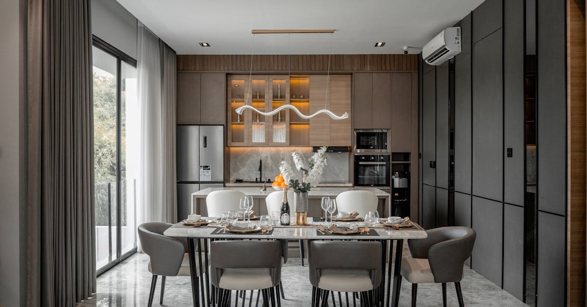 Sophisticated dining room setup in a modern home featuring sleek design and neutral tones.