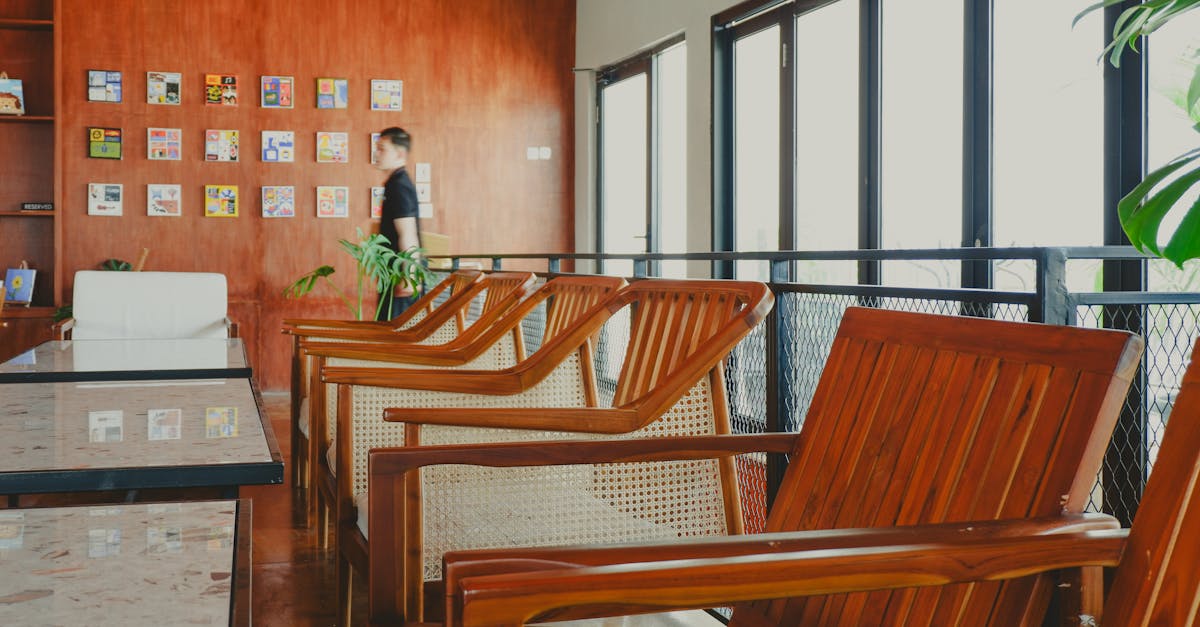 Cozy cafe space featuring wooden chairs and warm decor in a relaxed ambiance.