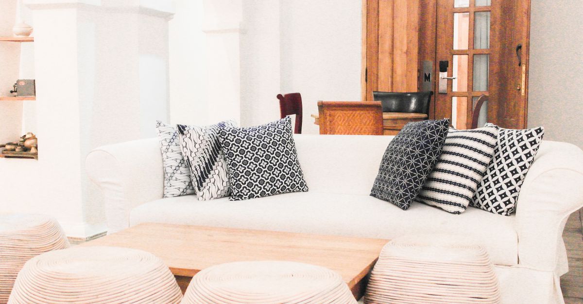 Stylish living room in Yogyakarta featuring a white sofa and patterned pillows, perfect for a modern home.