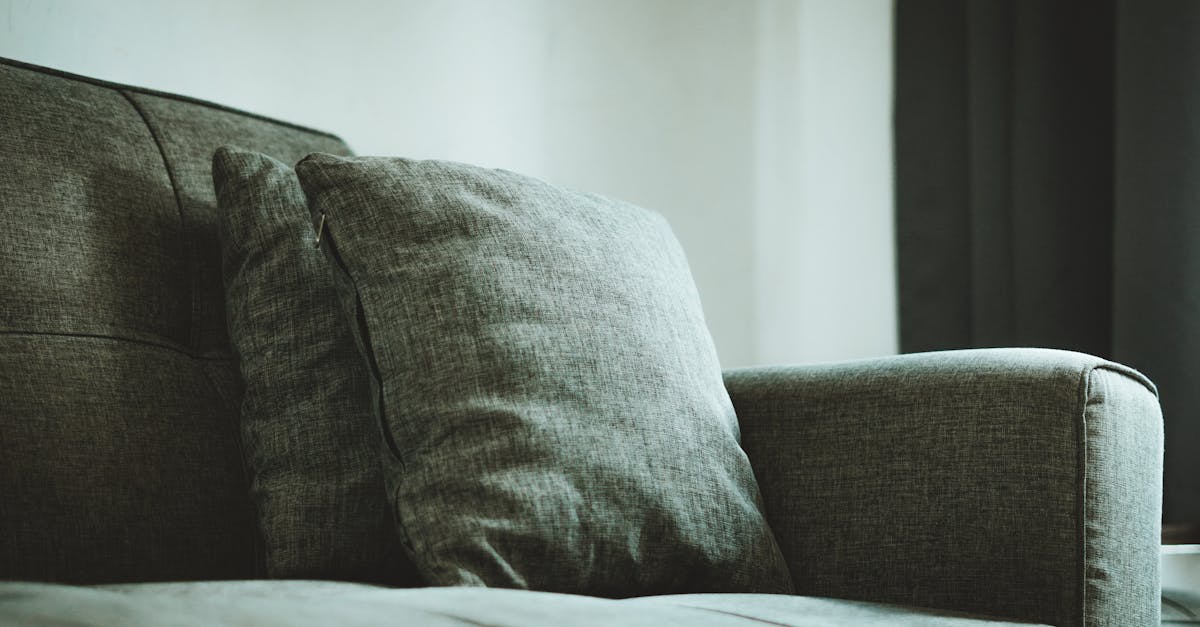 A close-up of a modern gray sofa with plush cushions, creating a cozy setting in a Jakarta home.