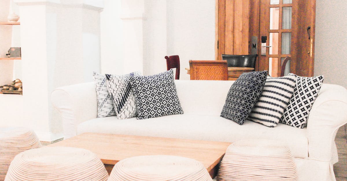 Stylish living room in Yogyakarta featuring a white sofa and patterned pillows, perfect for a modern home.