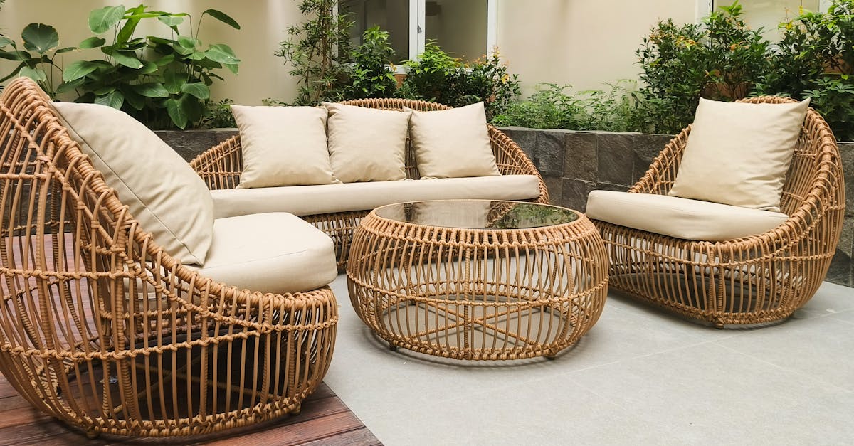 Outdoor seating with rattan furniture set in a lush garden patio, ideal for relaxation and gatherings.