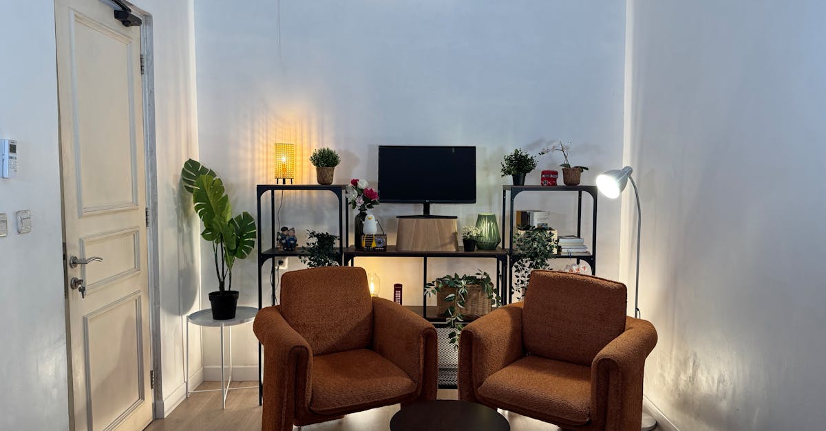 Inviting home office with cozy armchairs, plants, and well-organized shelves.