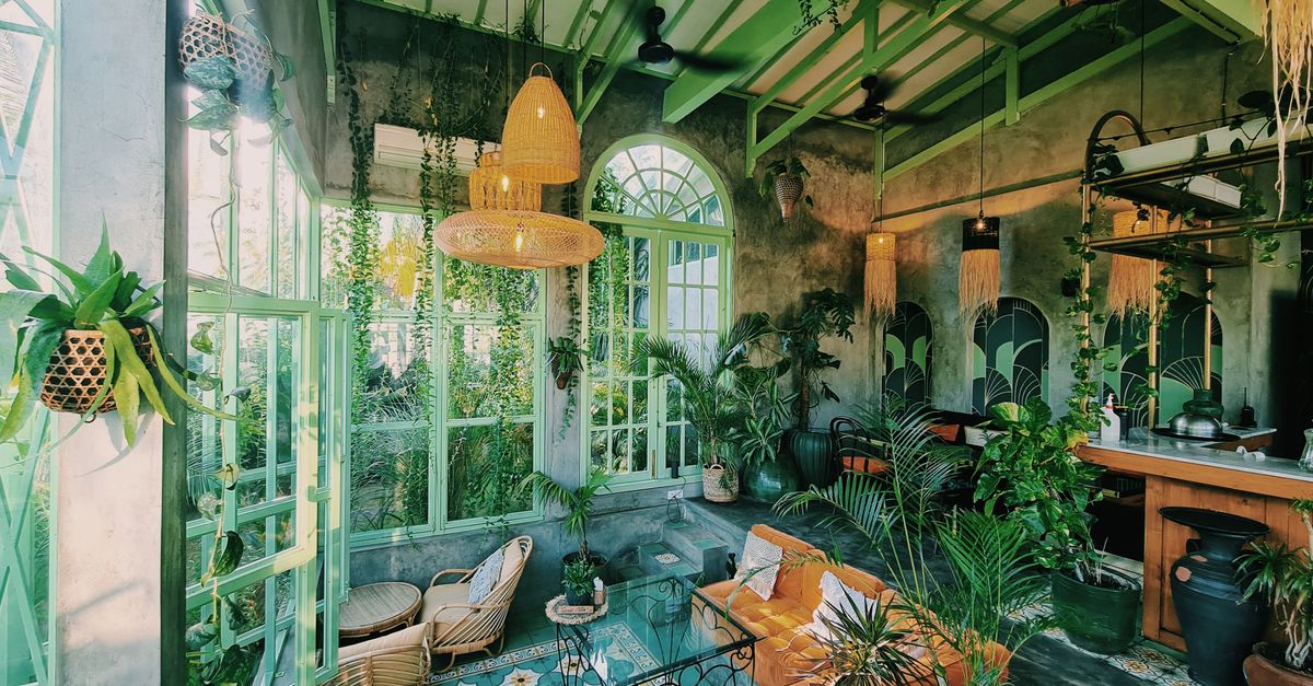 A beautifully decorated cafe in Bali, Indonesia, featuring lush greenery and vintage style.