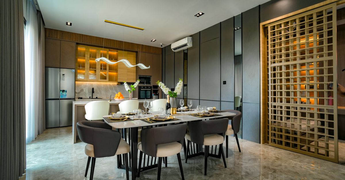A stylish dining room setup in a modern apartment in Jakarta with contemporary lighting and furniture.