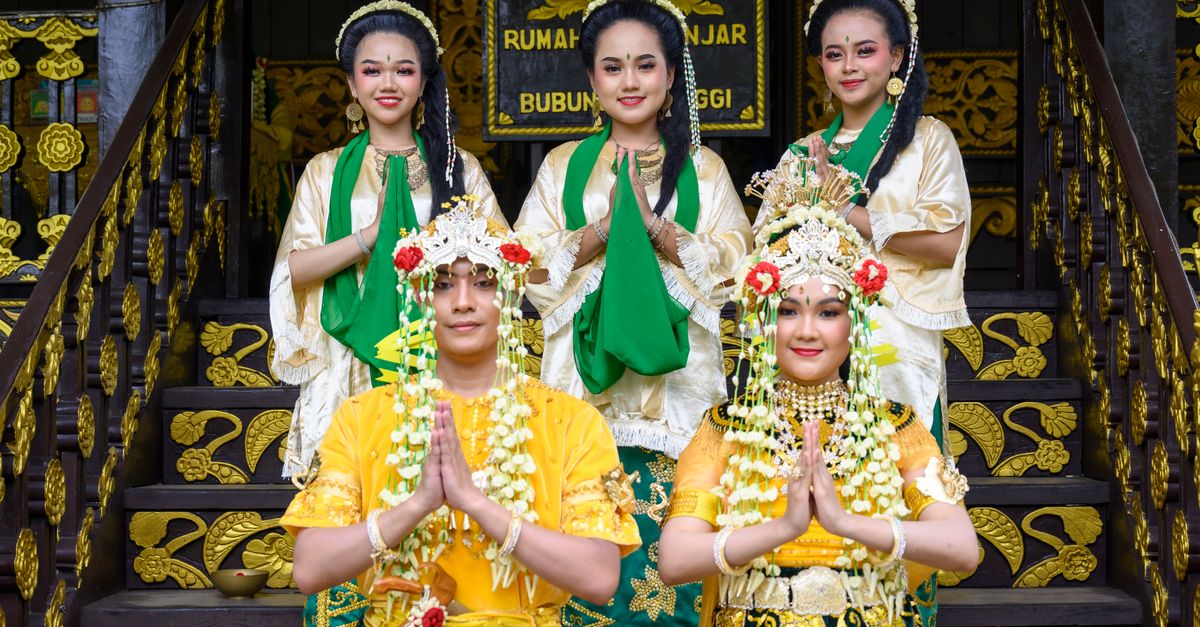 Traditional Minangkabau wedding attire worn during a ceremony in Bukittinggi, Indonesia. Cultural heritage celebration.
