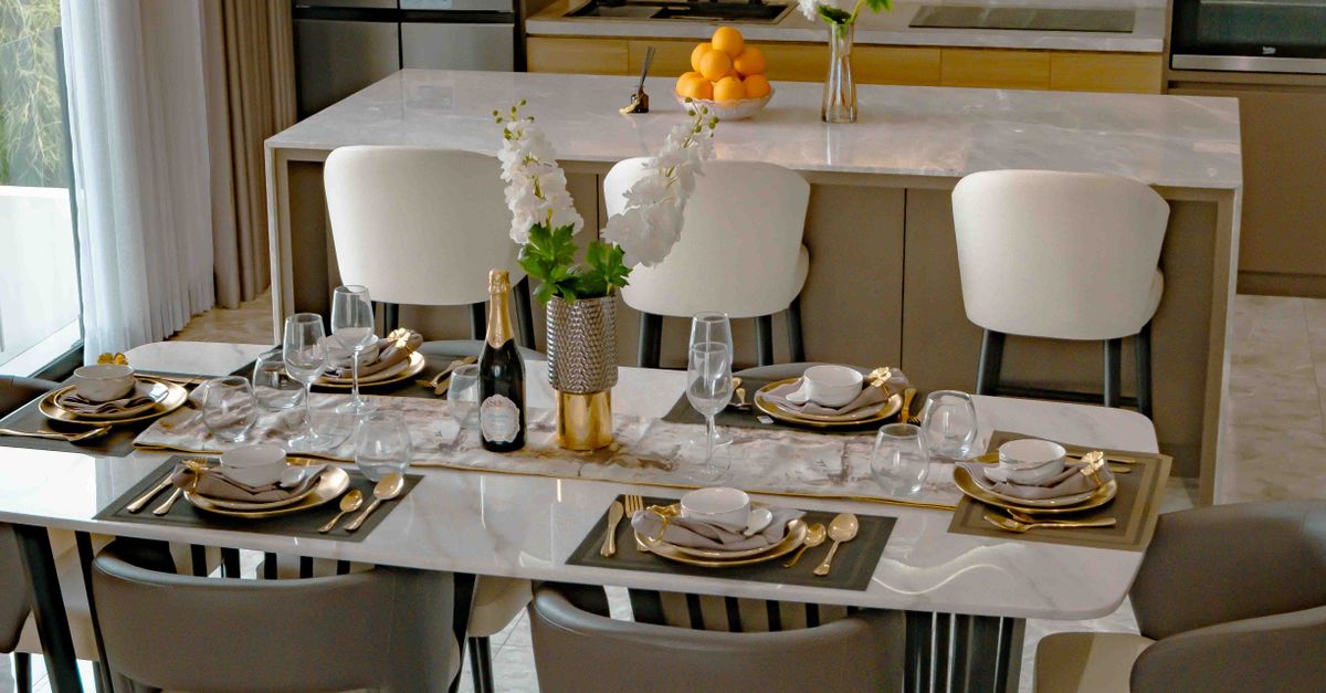 A luxurious dining setup with a modern kitchen backdrop, styled for a formal meal.